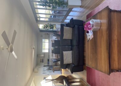 View towards kitchen from lounge. Please see two extra dining chairson the left of this photo. They can be moved to the dining table to allow 10 people to sit at the table.